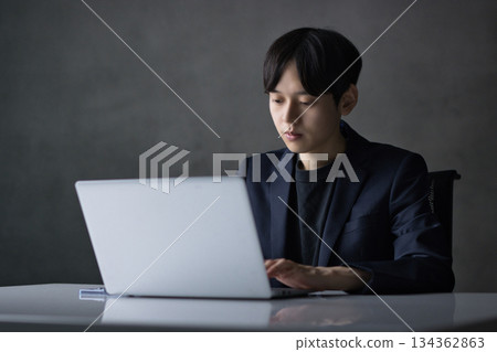 Young businessman working on a computer Young businessman working on a computer 134362863