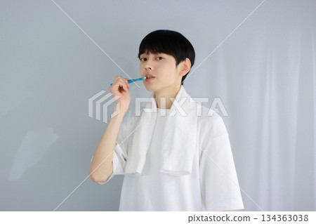 Oral care: A young man holding a toothbrush Oral care: A young man holding a toothbrush 134363038