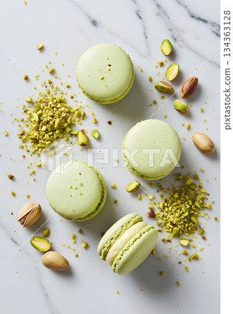 Green Pistachio Macarons with Scattered Nuts on Marble 134363128