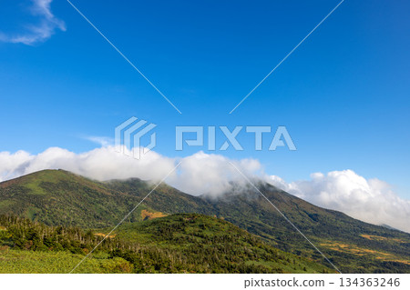 A clear day with forests covering the slopes of Mt. Hakkoda and clouds moving by A clear day with forests covering the slopes of Mt. Hakkoda and clouds moving by 134363246
