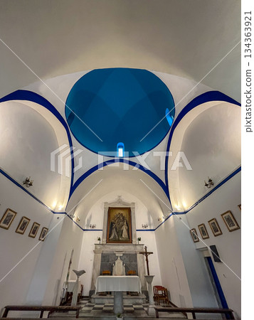 White interior of a traditional greek orthodox chapel with a vibrant blue dome, showcasing the island's culture, architecture, and religious heritage in mykonos, greece White interior of a traditional greek orthodox chapel with a vibrant blue dome, showcasing the island's culture, architecture, and religious heritage in mykonos, greece 134363921