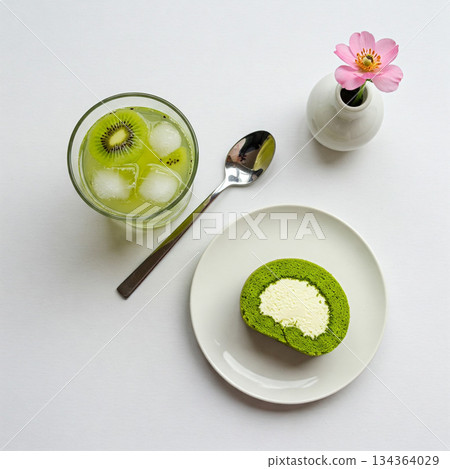 Green Tea Matcha Roll Cake with Whipped Cream and Iced Kiwi Drink 134364029