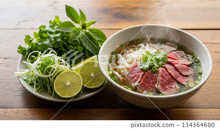 Steaming Beef Pho with Lemongrass Herbs and Lime 134364680