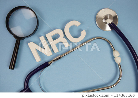 NRC Nutrition Rehabilitation Center text with Stethoscope and magnifying glass on blue background 134365166