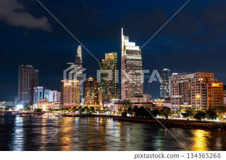 Ho Chi Minh City, Vietnam June 23, 2025: Sunset at district 1, view to Bitexco Financial Tower with Vietnam flag on the top building. One of the famous buildings in ho chi minh city view point. Ho Chi Minh City, Vietnam June 23, 2025: Sunset at district 1, view to Bitexco Financial Tower with Vietnam flag on the top building. One of the famous buildings in ho chi minh city view point. 134365268