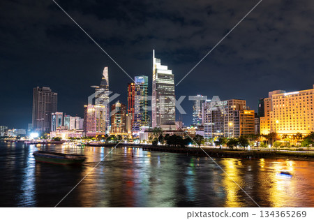 Ho Chi Minh City, Vietnam June 23, 2025: Sunset at district 1, view to Bitexco Financial Tower with Vietnam flag on the top building. One of the famous buildings in ho chi minh city view point. Ho Chi Minh City, Vietnam June 23, 2025: Sunset at district 1, view to Bitexco Financial Tower with Vietnam flag on the top building. One of the famous buildings in ho chi minh city view point. 134365269