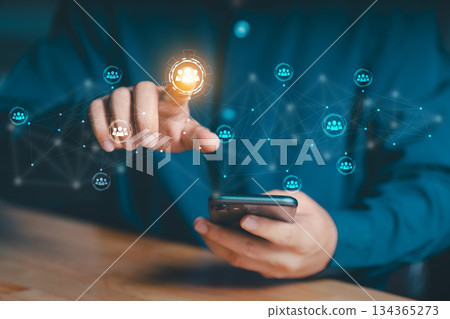 Holographic display of interconnected user icons, symbolizing social networking or team collaboration. Represents the integration of mobile technology with digital connectivity and human resources 134365273