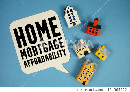 Home Mortgage Affordability text with house models on blue background 134365322