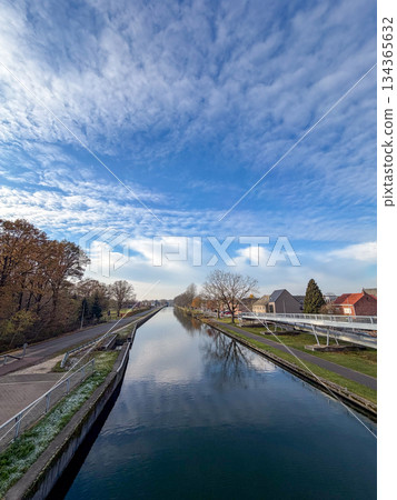 Rijkevorsel, Antwerpse Kempen, Belgium, Calm reflective scene featuring parallel banks and modern Rijkevorsel, Antwerpse Kempen, Belgium, Calm reflective scene featuring parallel banks and modern 134365632