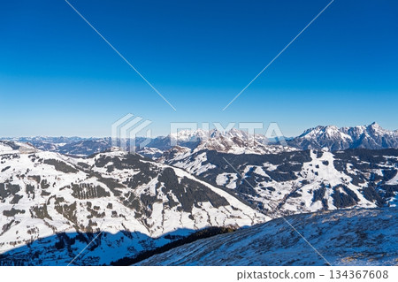 Snowy Mountain Peaks in Kaprun, Austria Alps Under a Clear Blue Sky. Winter Landscape Snowy Mountain Peaks in Kaprun, Austria Alps Under a Clear Blue Sky. Winter Landscape 134367608