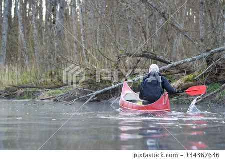 Paddling Through Serene Waters Person Kayaking on a Peaceful River in Nature s Embrace 134367636