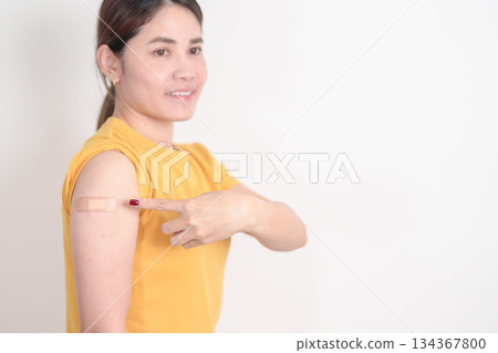 Adult Woman with bandage after received vaccine. Vaccination and Immunization for Influenza, HPV, Zoster, IPD, DTP or Diphtheria, Tetanus and Pertussis, MMR, Hepatitis B, Covid and Varicella vaccine 134367800