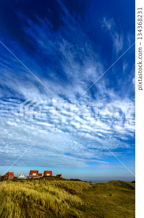 A Beautiful Scenic Coastal Landscape Featuring Dramatic Clouds, Rolling Dunes, and Serenity A Beautiful Scenic Coastal Landscape Featuring Dramatic Clouds, Rolling Dunes, and Serenity 134368231