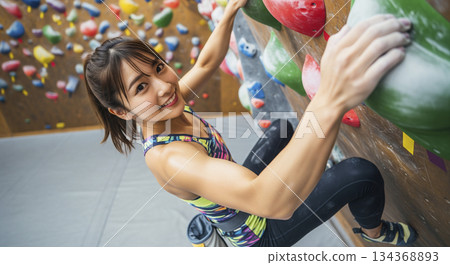 A woman sweating while bouldering 134368893