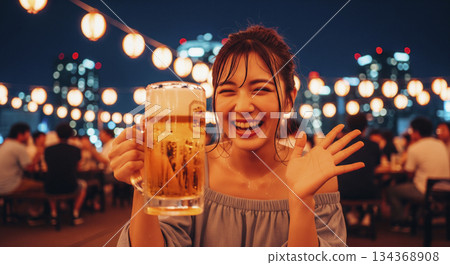 Young women toasting in a beer garden Young women toasting in a beer garden 134368908
