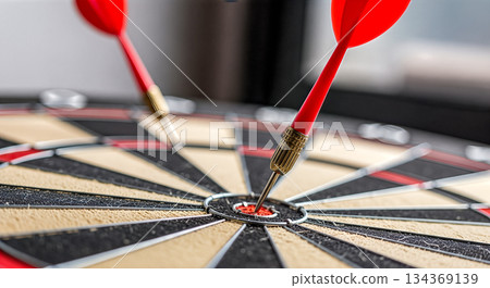 two red darts hitting bullseye center of dartboard precision focus accuracy success objective goal achievement concept 134369139