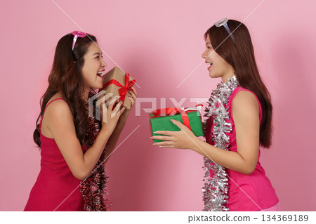 Joyful Gift Sharing. Friends celebrating with wrapped presents and laughter. 134369189