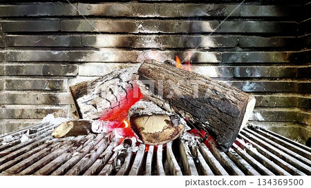 Burning Wood Logs in Brick Fireplace Burning Wood Logs in Brick Fireplace 134369500