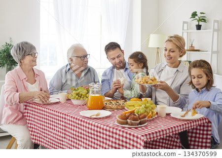 Healthy meal together at home, big three generation family enjoying lunch break, supper at home Healthy meal together at home, big three generation family enjoying lunch break, supper at home 134370599