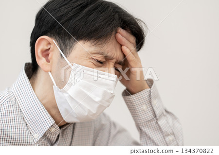 Man in poor health, headache 134370822