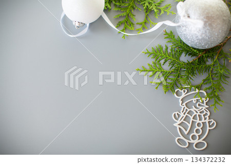 Winter card with a fir branch and a New Year's decoration Winter card with a fir branch and a New Year's decoration 134372232