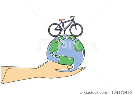 One line drawing of a bicycle on top of a globe held by a hand, nature concept, eco-friendly theme for World Bicycle Day, minimalist style symbolizing planet care through cycling. 134372450