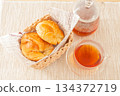 Croissants and healthy rooibos tea served in a basket 134372719