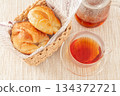 Croissants and healthy rooibos tea served in a basket 134372721