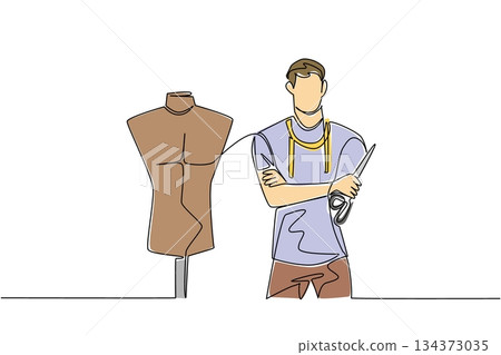 A young man tailor stands with mannequin and scissors in single line drawing style, emphasizing tailoring business concept, garment craft, and recognition of artisans on National Tailors Day. 134373035