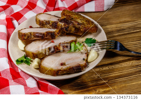 Baked pork belly in a plate on wooden table Baked pork belly in a plate on wooden table 134373116