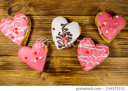 Heart shaped cookies on wooden table. Top view. Dessert for Valentine day Heart shaped cookies on wooden table. Top view. Dessert for Valentine day 134373131