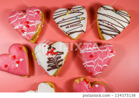 Heart shaped cookies on pink background. Top view. Dessert for Valentine day Heart shaped cookies on pink background. Top view. Dessert for Valentine day 134373136