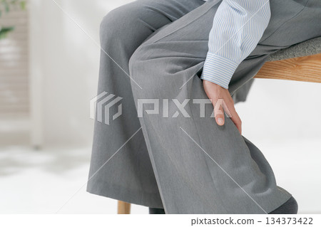 Woman holding her feet 134373422