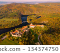 Beautiful autumn landscape with a castle from above from a drone. Beautiful Gothic castle Veveri. The city of Brno at the Brno dam. South Moravia Czech Republic Central Europe. 134374750