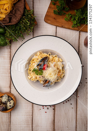 Creamy pasta with mussels and cheese Creamy pasta with mussels and cheese 134375297
