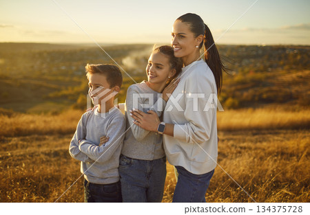 Mother Embracing Children During Nature Walk On Weekend Vacation 134375728