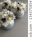 A winter-inspired arrangement of white flowers and dried flowers 134375854