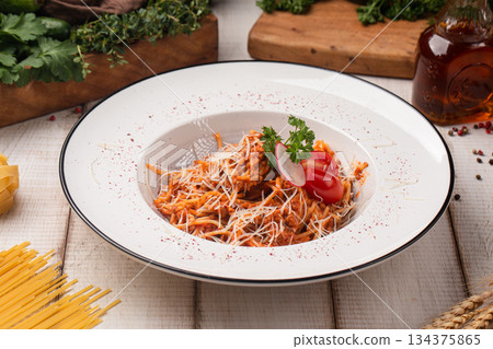 Spicy tomato pasta with grated cheese 134375865