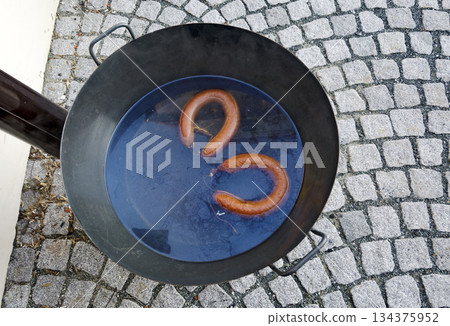 hot sausages in a cauldron hot sausages in a cauldron 134375952
