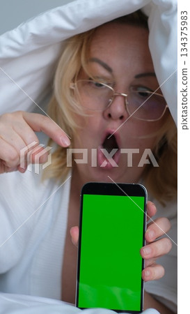 green screen for chroma key advertising Shocked lady staring at smartphone with open mouth. Middle-aged woman reading surprising message on phone, amazing news at night green screen for chroma key advertising Shocked lady staring at smartphone with open mouth. Middle-aged woman reading surprising message on phone, amazing news at night 134375983
