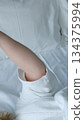 Cheerful adult woman taking selfie with phone while resting on bed in the morning. Happy millennial female sharing self portrait on social media network. 134375994