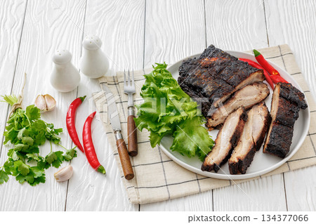 charred pork chunk served on a white platter charred pork chunk served on a white platter 134377066