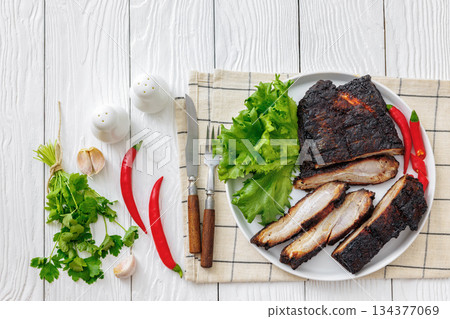 charred pork chunk served on a white platter charred pork chunk served on a white platter 134377069