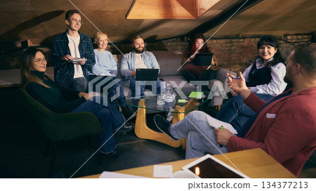 Startup team discussion in modern coworking lounge area. Startup team discussion in modern coworking lounge area. 134377213