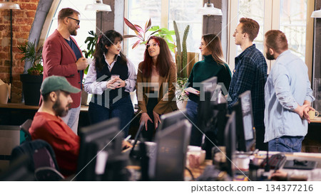 Team conversation in relaxed modern coworking office. Team conversation in relaxed modern coworking office. 134377216