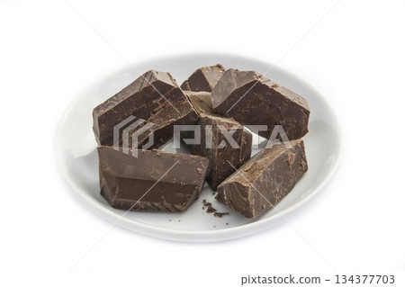 Dark chocolate in a white plate Dark chocolate in a white plate 134377703