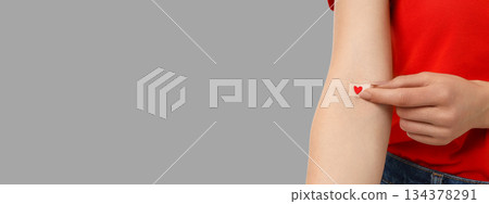 Donor removes bandage after blood donation, space for text 134378291