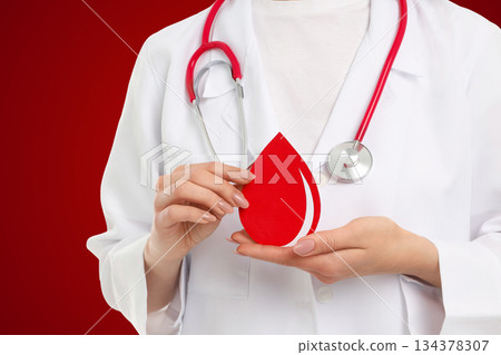 Blood donation process shown with person holding a drop symbol Blood donation process shown with person holding a drop symbol 134378307