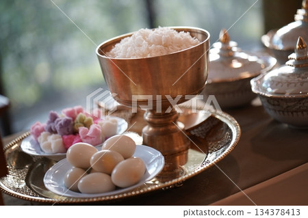 Thai bowl set on table prepare for give food offerings to a Buddhist monk in the morning. People usually prepare rice, dishes and flower offer food to monk. 134378413