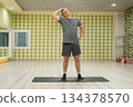 Neck stretch exercise by caucasian man in fitness studio 134378570